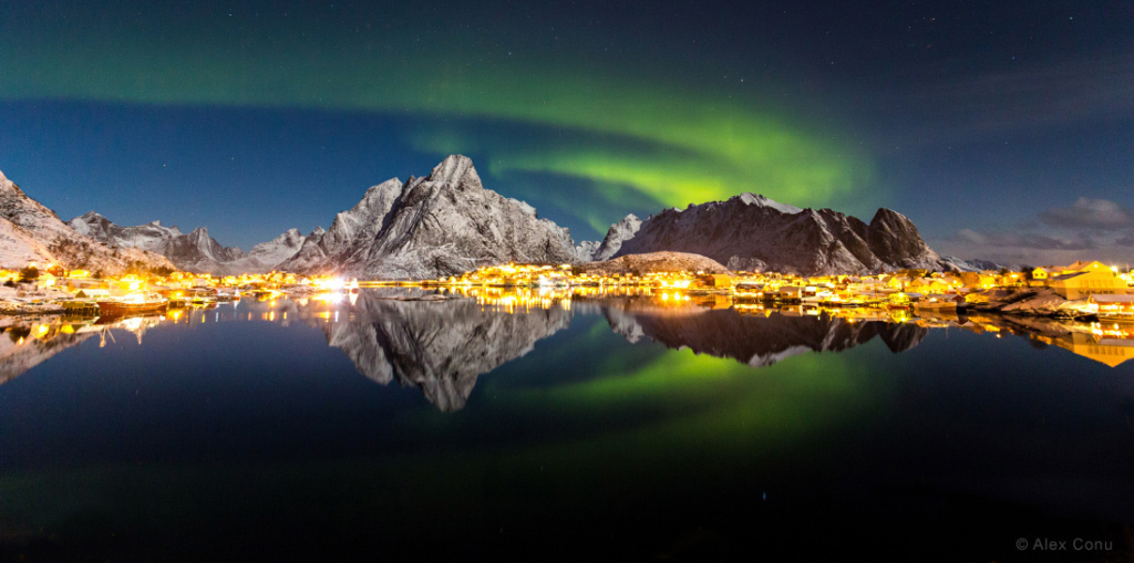 This is Reine, a Norwegian fishing village and tourist destination. The photo seems brightly lit because there was a lot of moonlight that night, photographer Alex Conu <a href="http://www.twanight.org/newTWAN/news.asp?newsID=6097">explained to contest judges</a>.