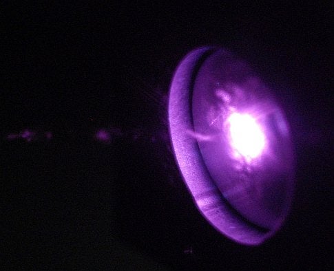 This shows "a laser impacting a target like the ones that we utilized in our experiments.  The glow is hot plasma that is produced by the laser.  The laser pulse produces the high-frequency acoustic wave that propagates through the piezoelectric thin films, generating THz radiation."
