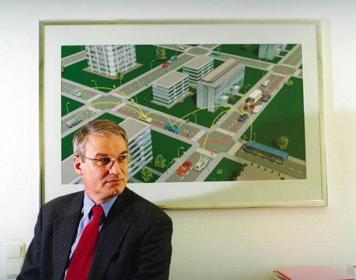 BMW's Raymond Freymann posing in front of a painting of a traffic system