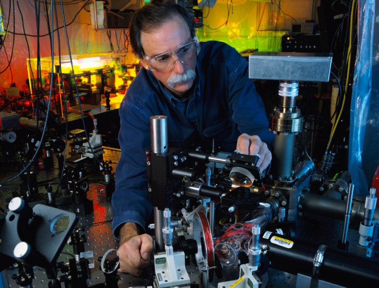 NIST physicist David Wineland adjusts an ultraviolet laser beam used to manipulate ions in a high-vacuum apparatus containing an "ion trap." These devices have been used to demonstrate the basic operations required for a quantum computer--and today won Wineland and fellow quantum physicist Serge Haroche a Nobel Prize.