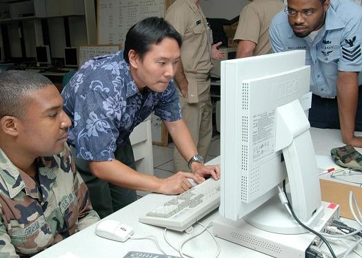 070712-N-9758L-058 PEARL CITY, Hawaii (July 12, 2007) Ð Matt Inaki, computer network defender coach/trainer of SPAWAR Systems Center San Diego, shows how to monitor the activity of a network to Air Force Staff Sgt. Daryl Graham and Information Systems Technician 1st Class Martin MacLorrain during a cyber war training course at the Space and Naval Warfare Systems Center. The course is designed to improve how military members would act in a real-life cyber war environment by defending the networks with sweeps and scans of the system as well as responding to intrusions, such as viruses and probes. U.S. Navy photo by Mass Communication Specialist 3rd Class Michael A. Lantron (RELEASED)