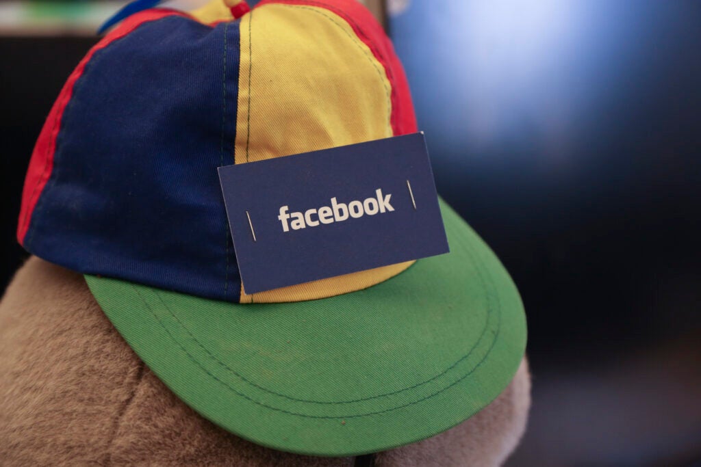 facebook card stapled to hat