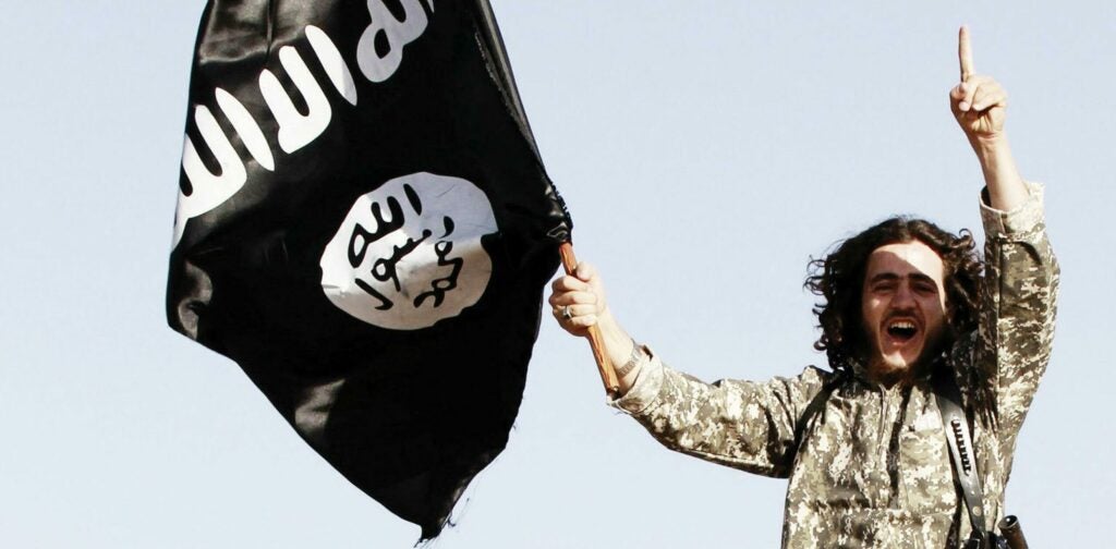 fighter with islamic state holding flag