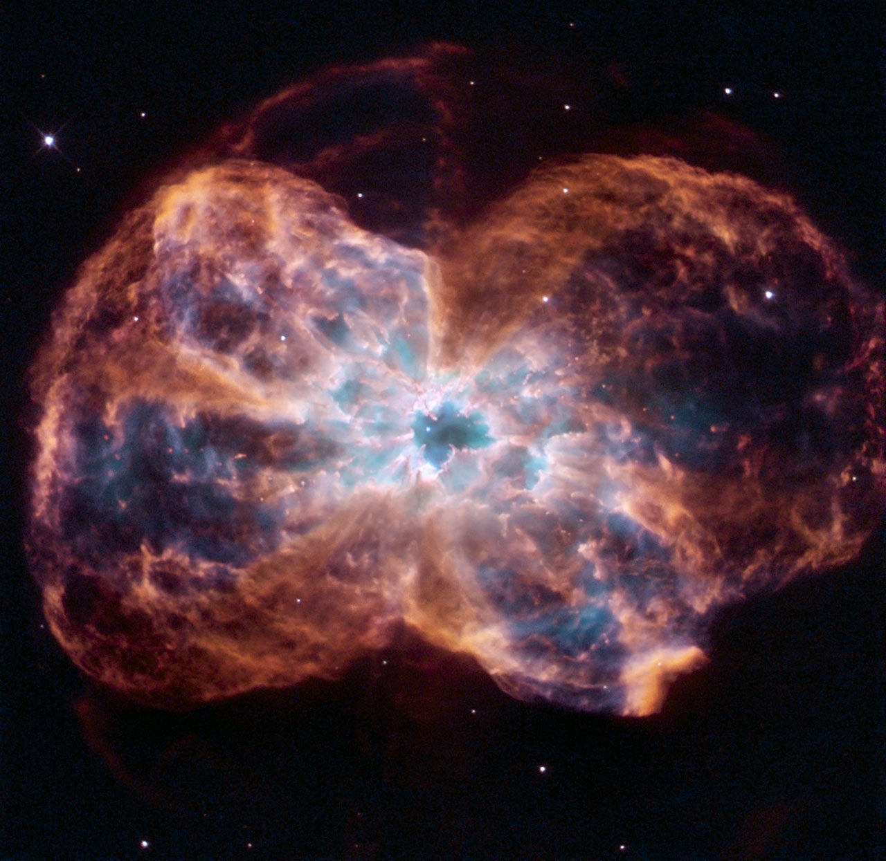 This image of NGC 2440 shows the colourful "last hurrah" of a star like our Sun. The star is ending its life by casting off its outer layers of gas, which formed a cocoon around the star's remaining core. Ultraviolet light from the dying star makes the material glow. The burned-out star, called a white dwarf, is the white dot in the centre.