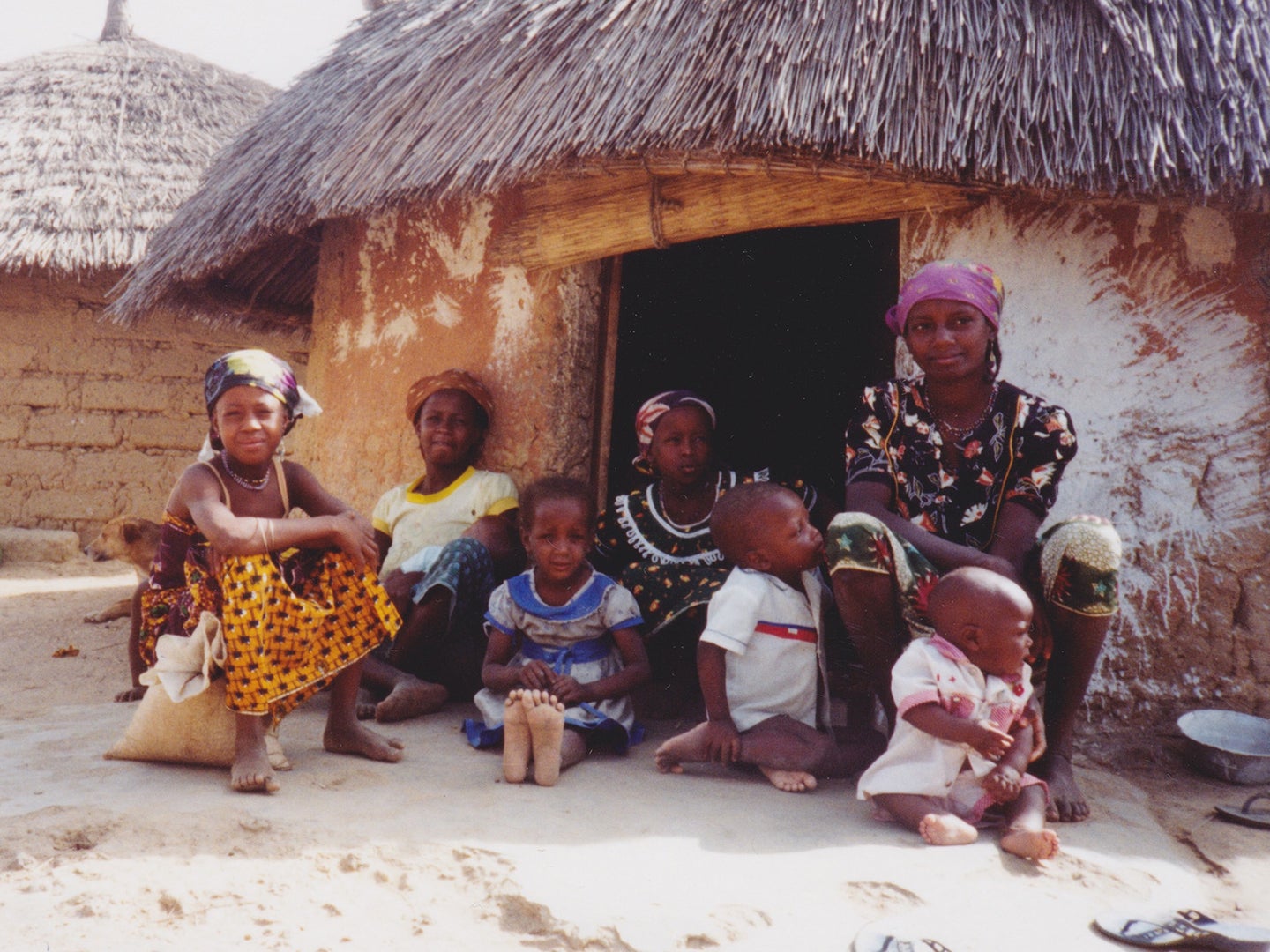 A mother and her children outside their home in rural Nigeria
