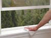 wiping dust from windowsill