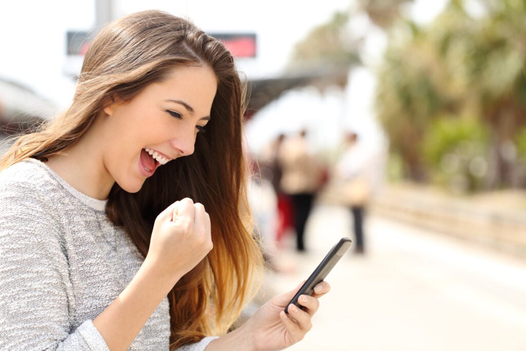 excited woman with phone