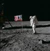 Astronaut Buzz Aldrin poses for photograph beside deployed U.S. flag