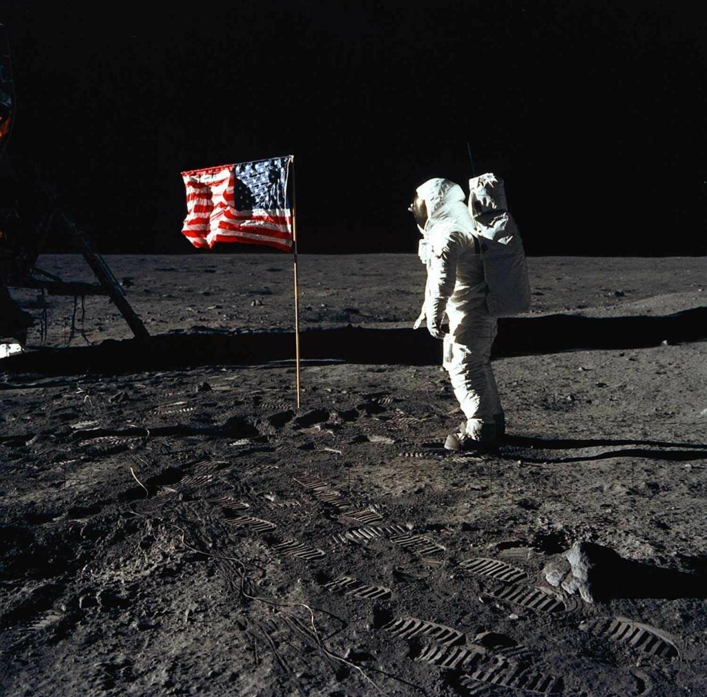 Man on the moon with an American Flag