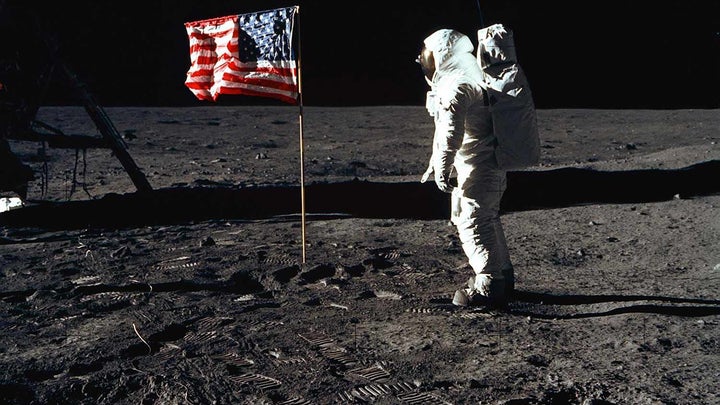 Man on the moon with an American Flag