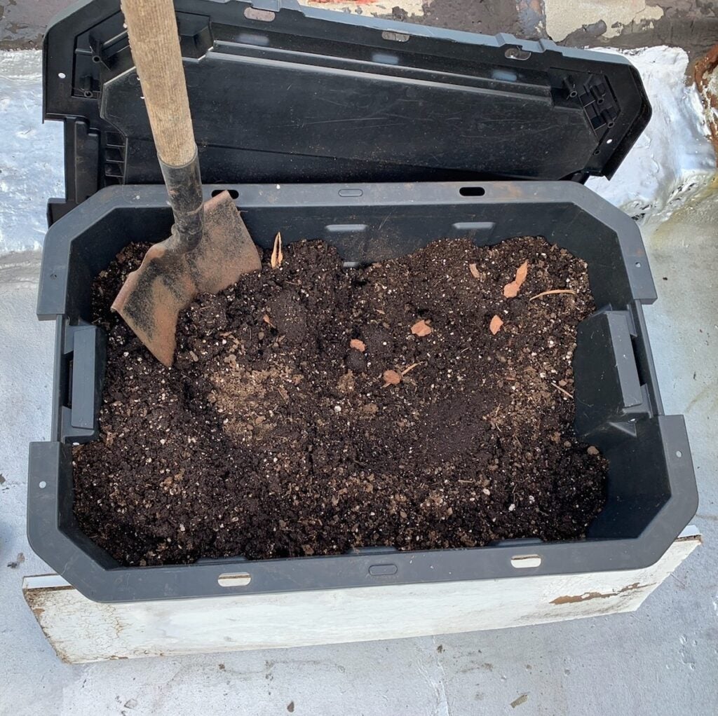 dirt in a container with a shovel