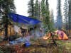 a backcountry hunting camp with a tarp over the kitchen