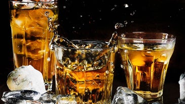 alcohol and ice in multiple glasses