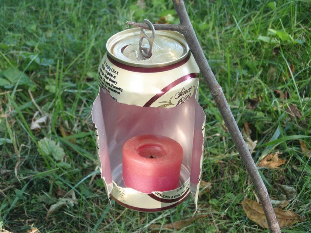 A candle lantern made from an empty beer can.