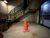 An orange cone under a staircase taken with the iPhone 11 Pro camera