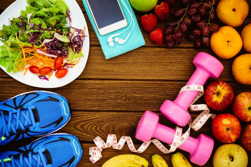 Food and exercise items on a wood table