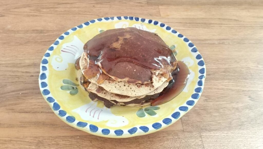 stack of pancakes covered in syrup