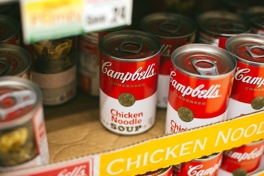 campbell's canned chicken noodle soup on a shelf