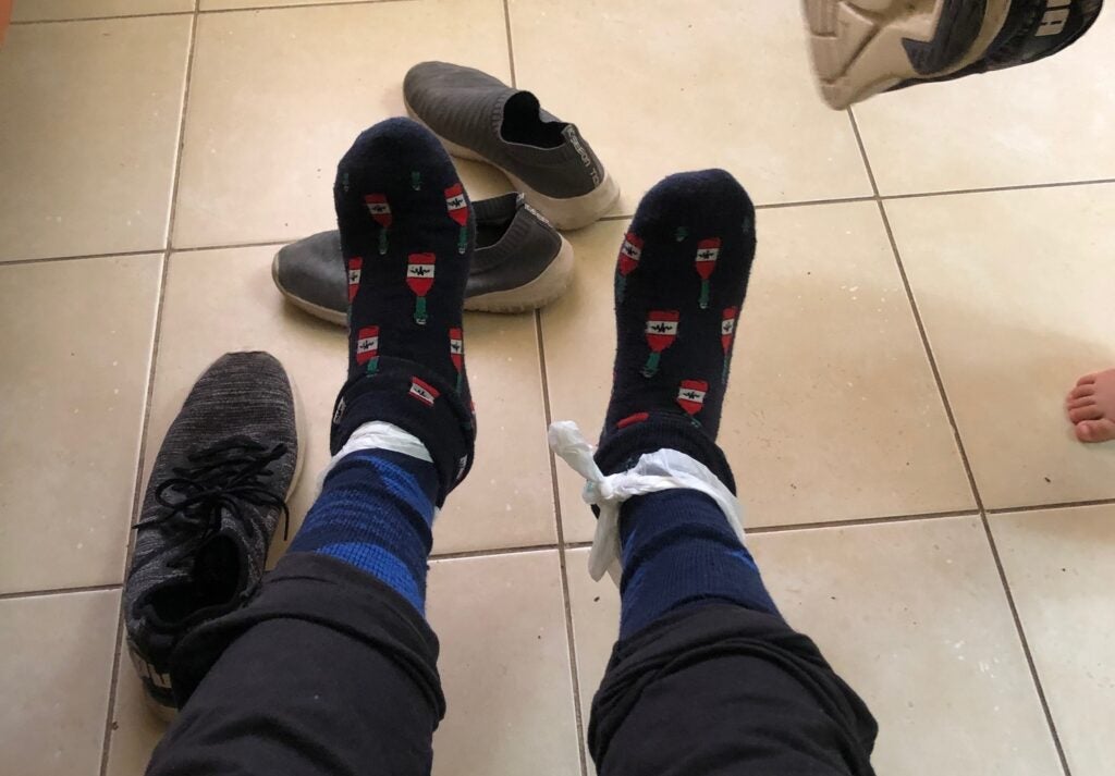 feet with plastic bags and socks on top