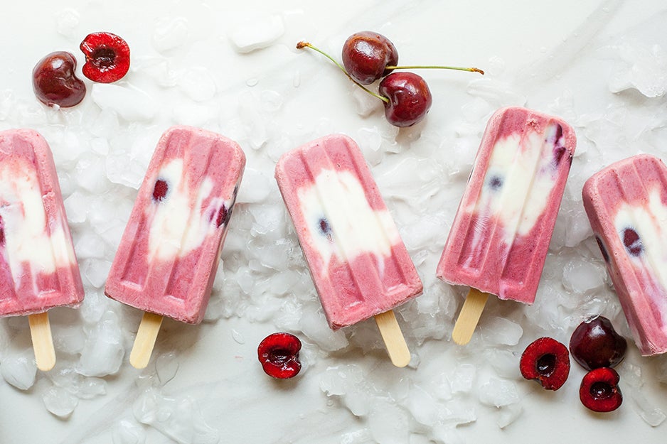 cherry ice pops on a marble surface