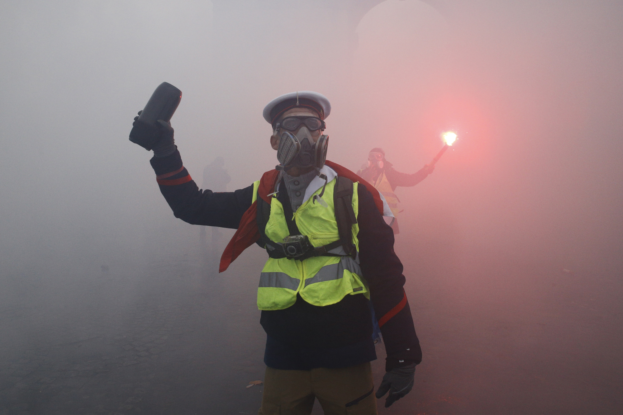 Riot Police uses a water canon and tear gas against demonstrators during  a protest against the rising of the fuel and oil prices by people wearing yellow vests.