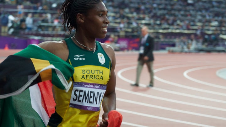 Caster Semenya on track with south african flag around her