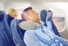 Person sleeping in plane with cervical neck pillow