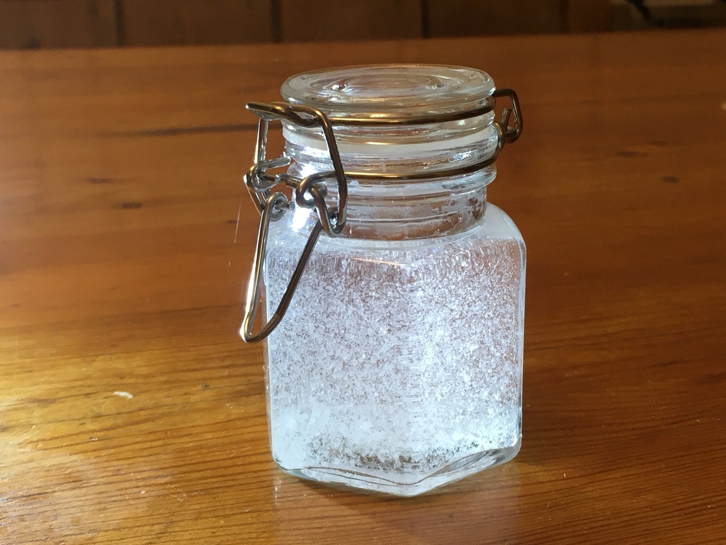 a storm glass on a wooden surface