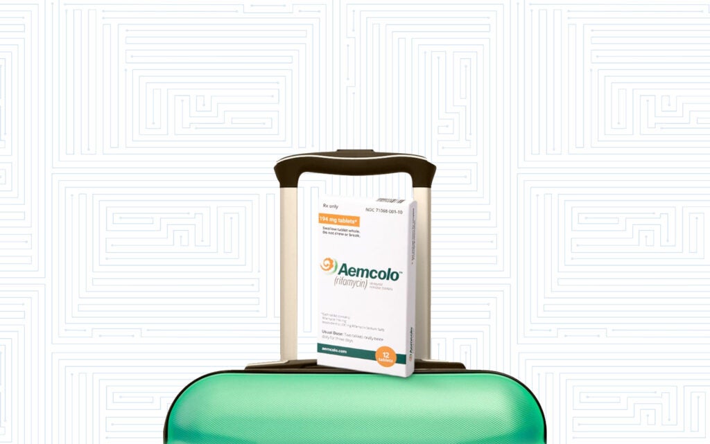 Aemcolo medicine on a green suitcase