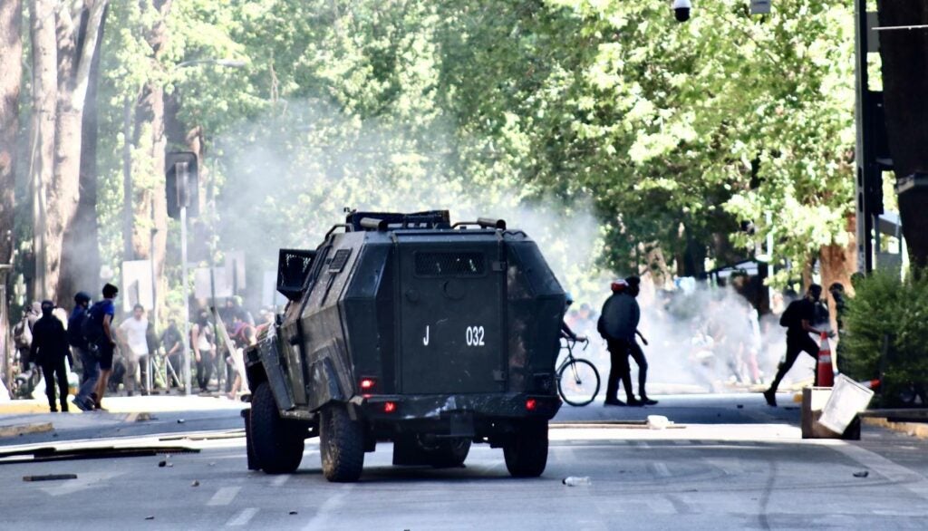 Police truck against a tear gas cloud in protests in Santiago, Chile.