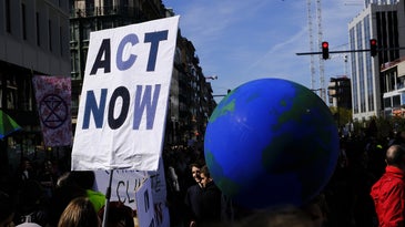 a large globe held up at a protest