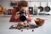 A photographer taking a close-up of food in a kitchen
