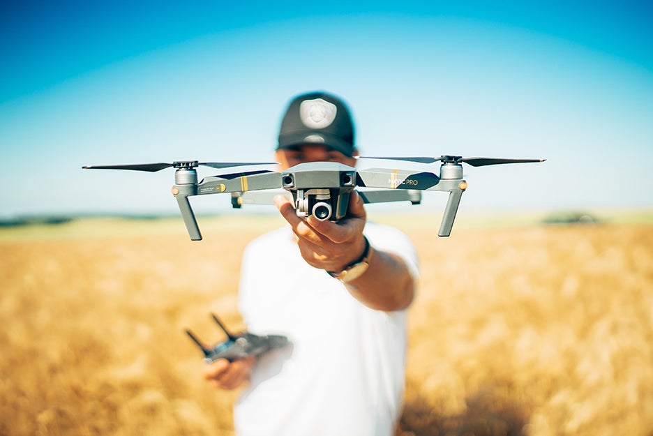 Guy with a drone in a field
