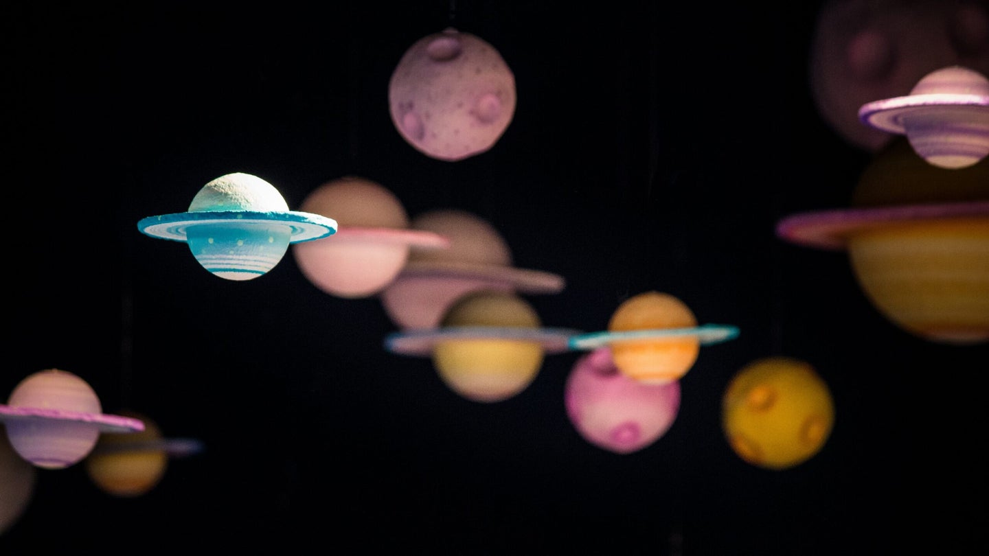 small colorful planets against a black background