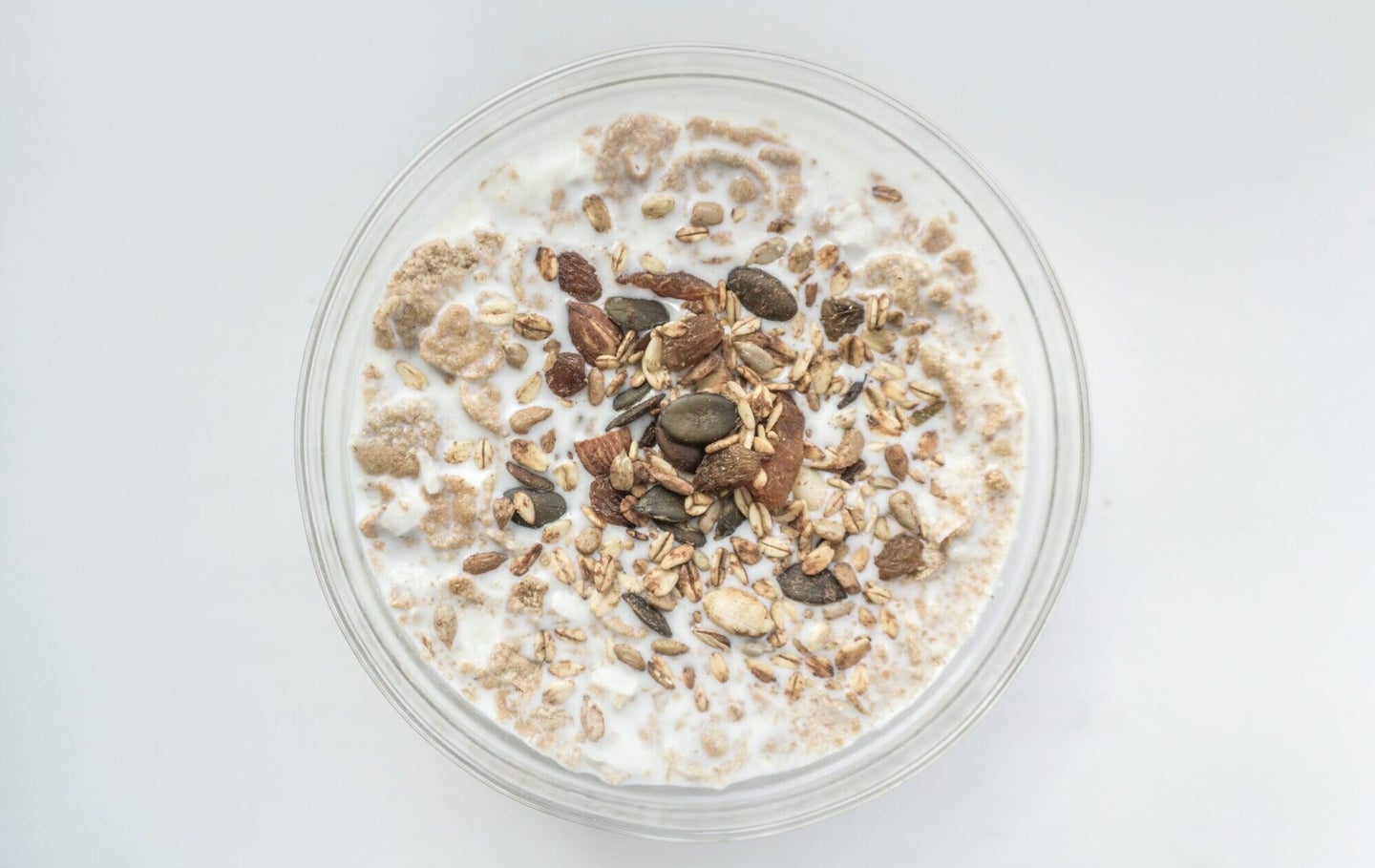 Bowl of oatmeal with milk on a white background. Are the oats gluten-free?