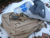 winter survival gear and water in the snow.