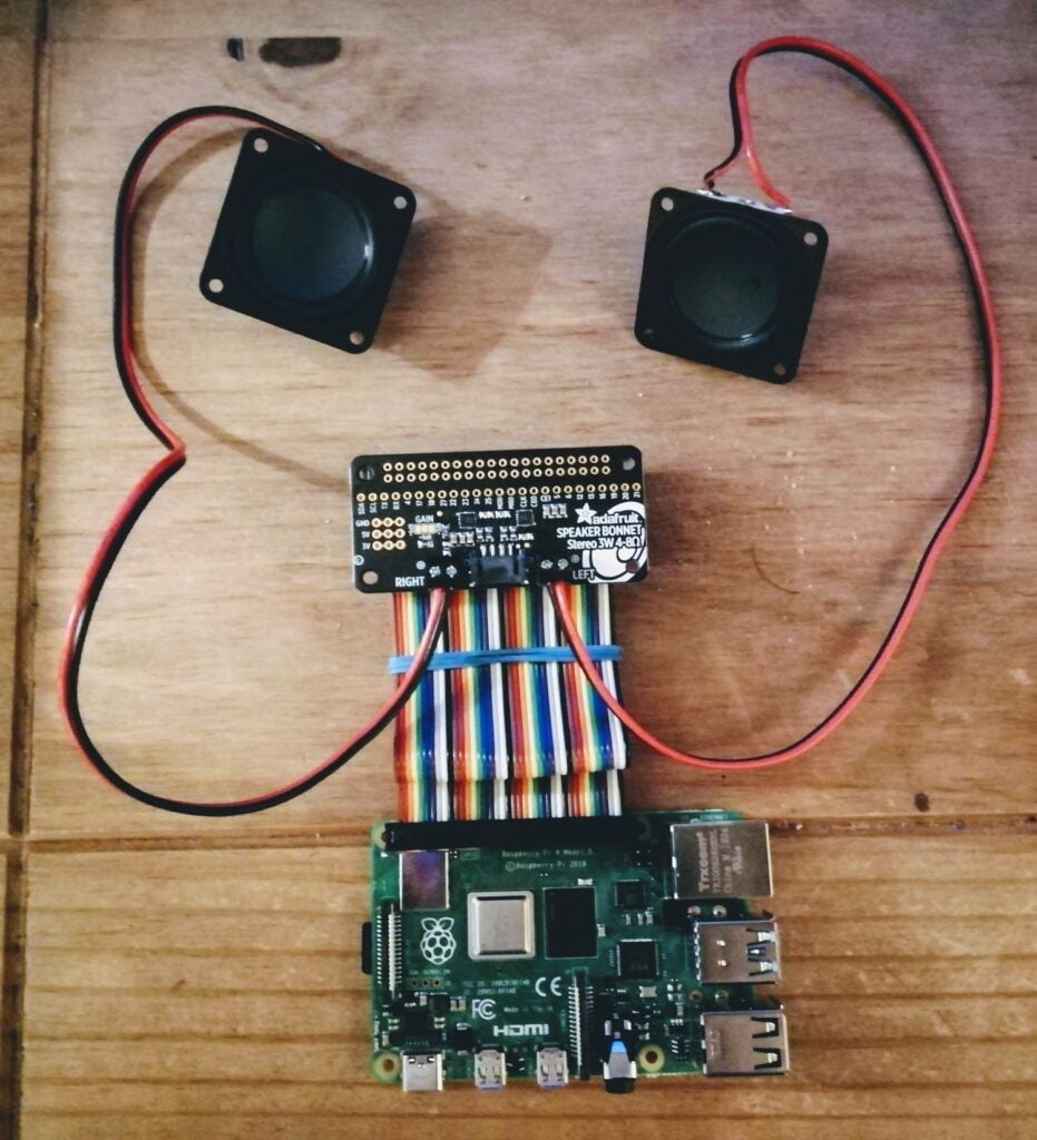 two speakers connected to an Adafruit speaker bonnet and a Raspberry Pi 4