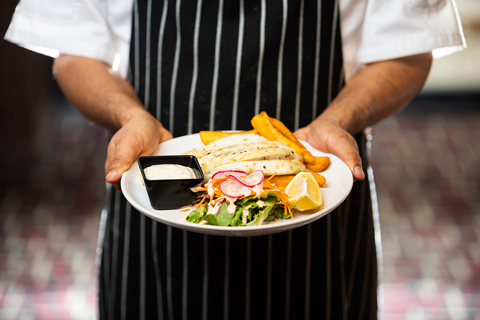 chef holding a plate of food