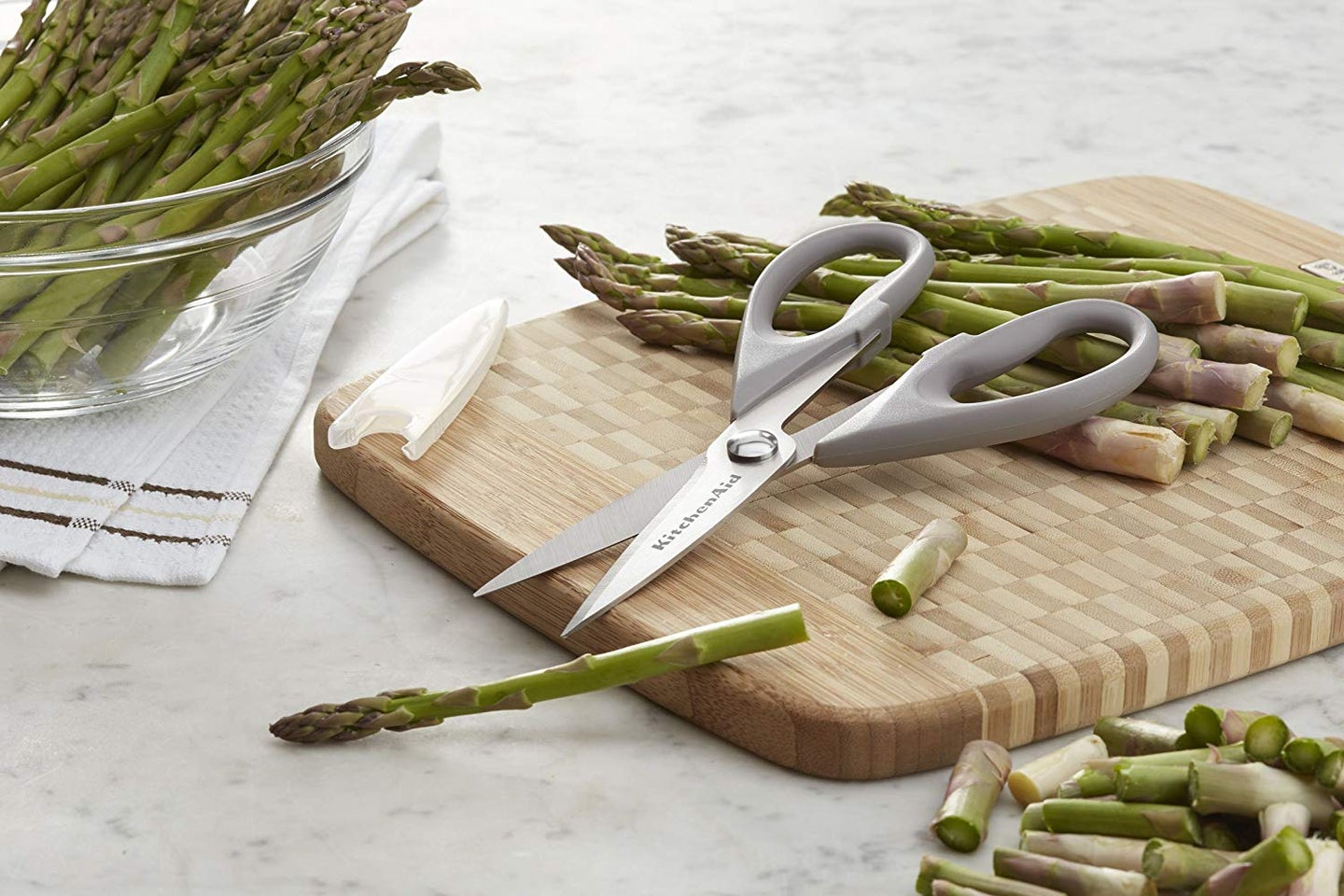 cutting board with asparagus and scissors