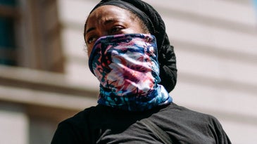 A person using a neck gaiter as a face mask.