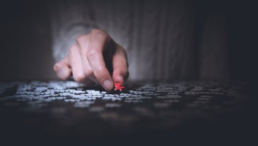jigsaw puzzle and a hand