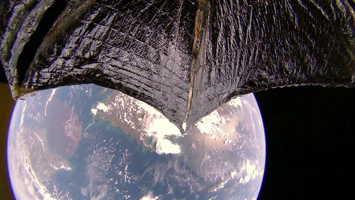 lightsail 2's wing in the foreground, Earth and Australia in the background