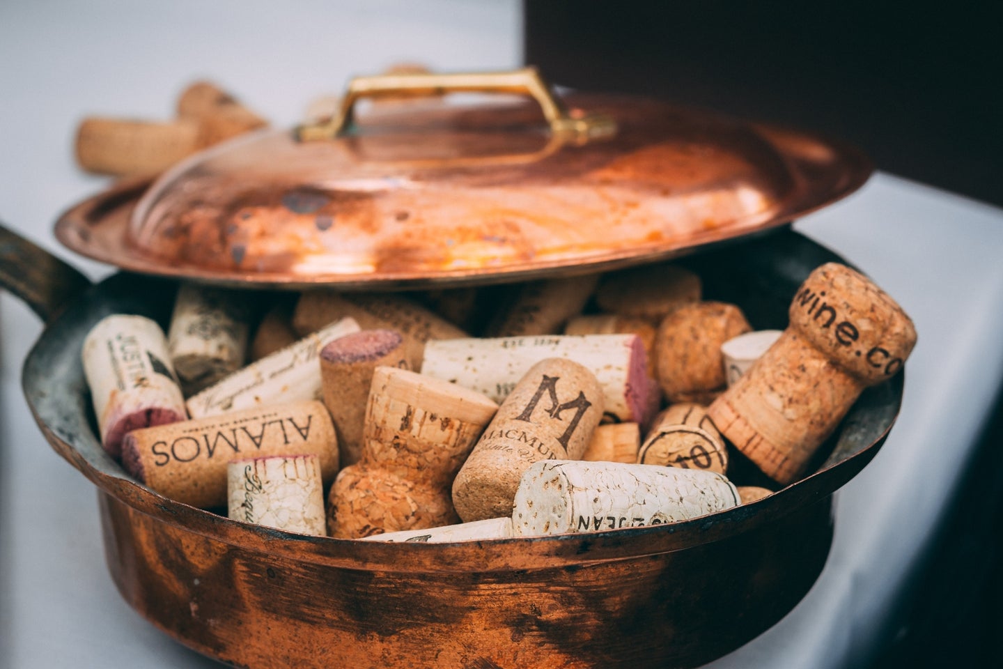 a copper pan full of wine corks