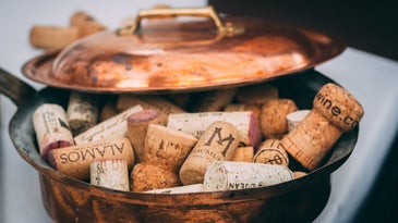 a copper pan full of wine corks
