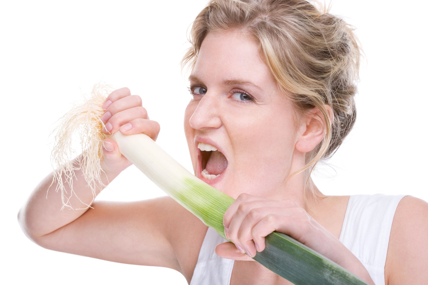 a woman is about to bite into a giant leek, for some reason