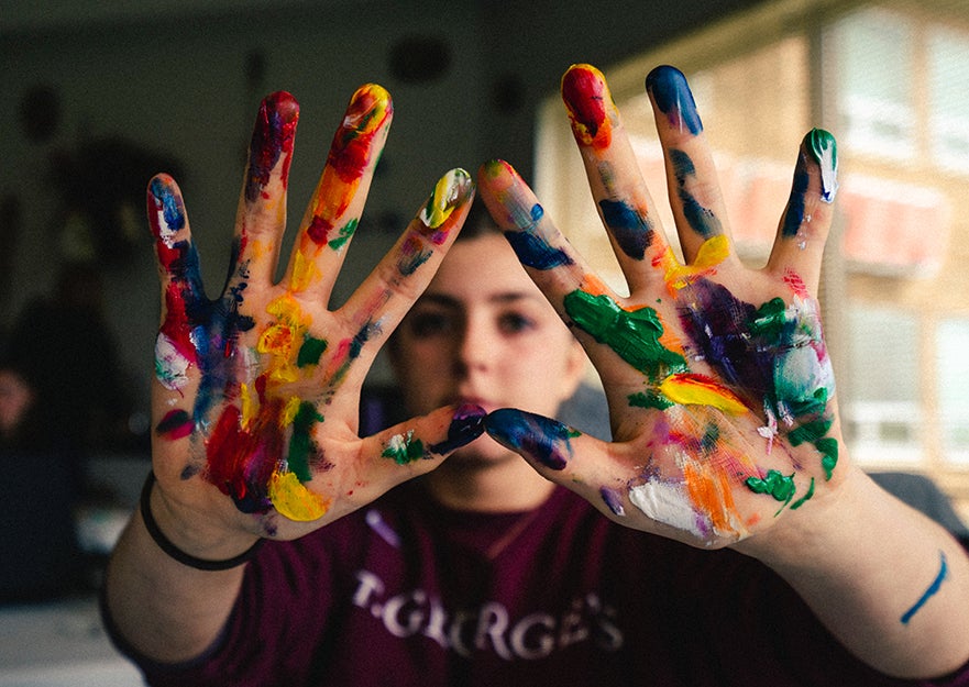 person with paint on their hands