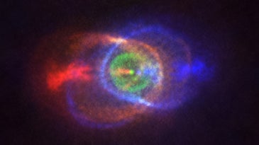 Two stars colliding and making a colorful cloud of gas