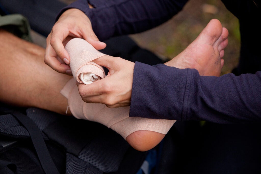 A leg tensor bandage being applied outdoors
