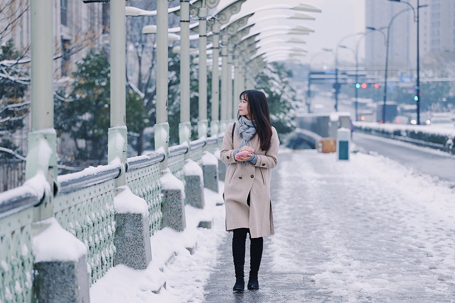 woman walking down a snowy street