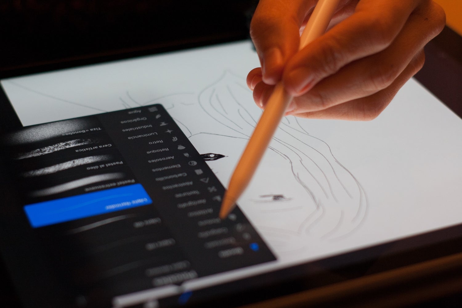 Tangan menggunakan iPad dengan stylus saat menggambar dan menggunakan Adobe Photoshop.